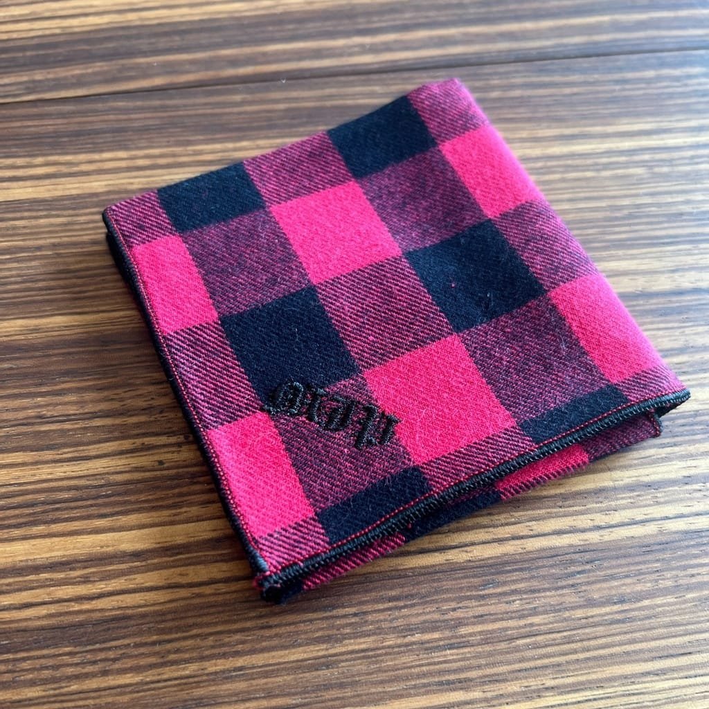 red and black plaid handkerchief with black gothic monogram